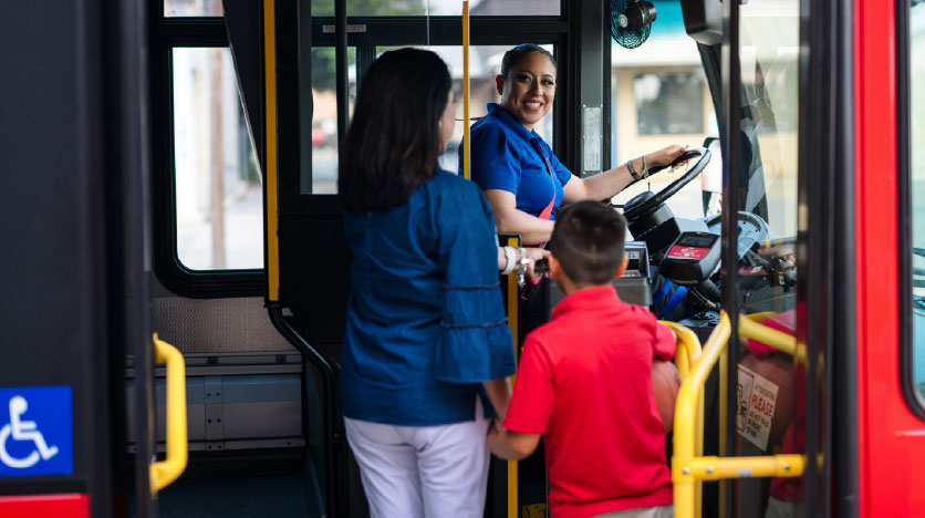 a mother and sun board the bus hand in hand