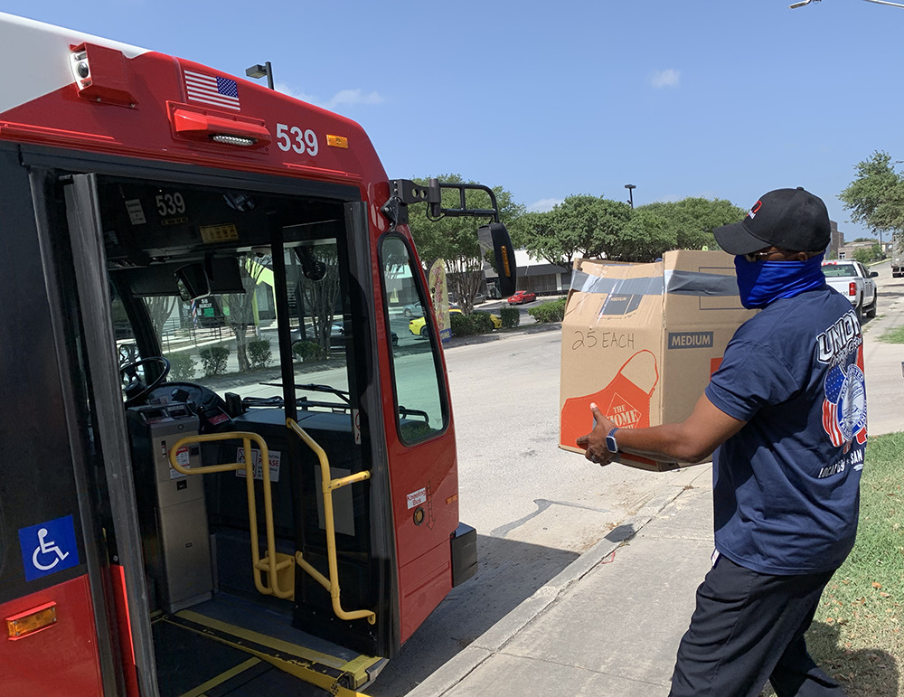 Volunteer carrying box to bus