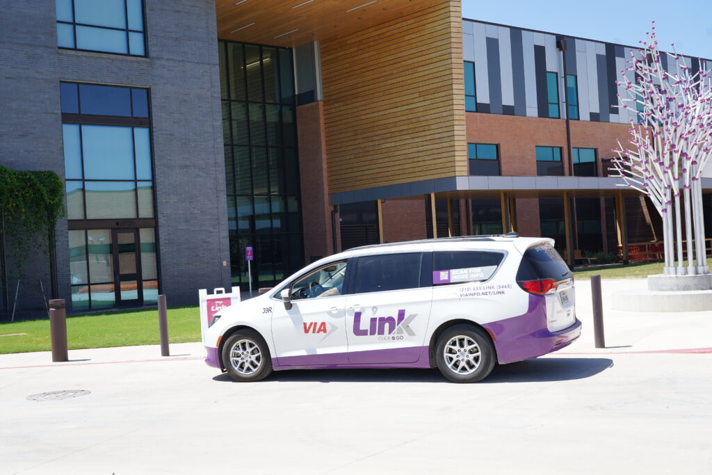Link van waits outside a building